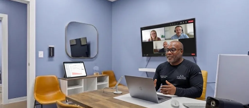 Coach Victor Davis leading a virtual wellness consultation from the Victory Health & Wellness clinic in Austin